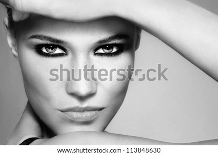 Close-up black and white portrait of beautiful stylish blonde girl with trendy make-up