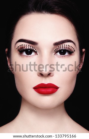 Portrait of beautiful girl with red lipstick and fancy false eyelashes