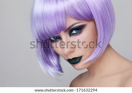 Portrait Of Young Beautiful Woman With Fancy Green Make-Up And Violet Wig