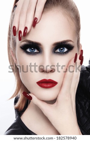 Portrait of young beautiful woman with smoky eyes and long nails over white background Portrait of young beautiful woman with smoky eyes and long nails over white background