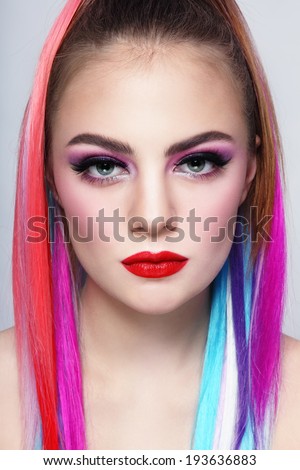 Portrait of young beautiful girl with colorful hair extensions
