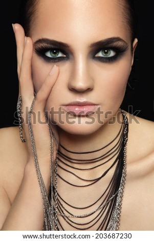 Portrait of young beautiful woman with smoky eyes and extended eyelashes