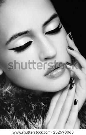 Close-up portrait of young beautiful woman with stylish cat eye make-up