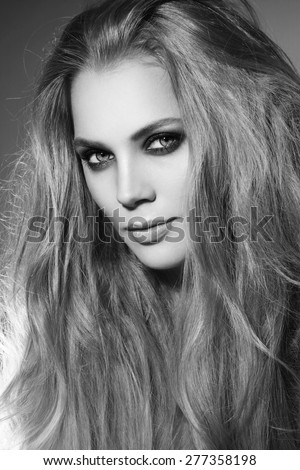 Black and white portrait of young beautiful stylish woman with long hair