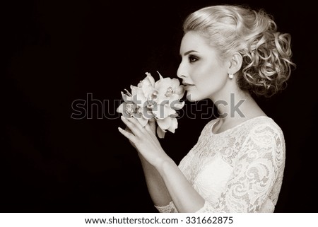 Duotone profile portrait of young beautiful bride with stylish prom hairdo