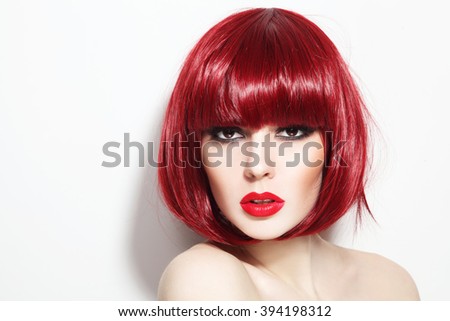 Portrait of young beautiful sexy red-haired girl with bob haircut and stylish make-up
