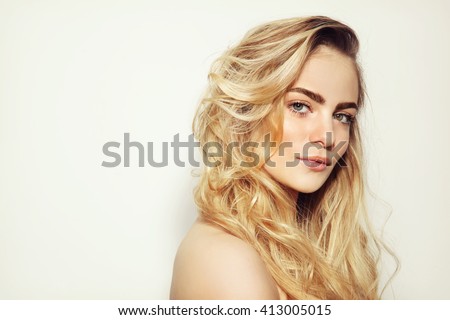 Portrait of young beautiful girl with long messy hair and clean make-up
