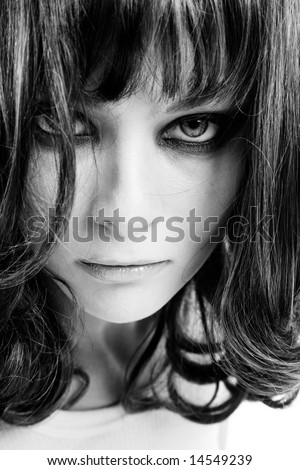 Black and white portrait of young girl looking like wild animal