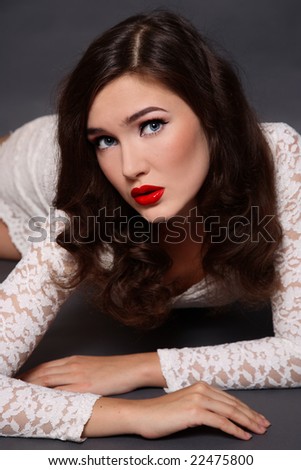 Beautiful girl with classical glamorous makeup in white dress