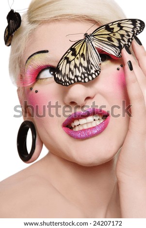 Beautiful blond smiling girl with bright makeup and big tropical butterfly on her face