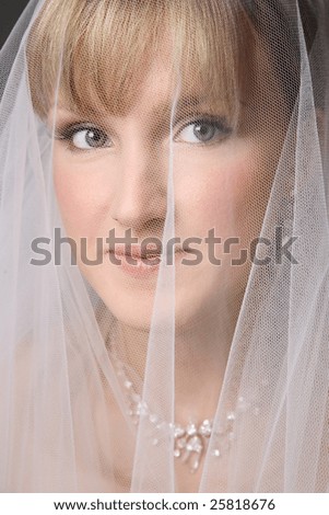 Portrait of young fresh beautiful bride under bridal veil