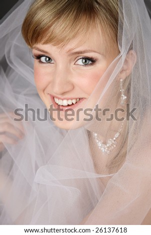 Portrait of happy smiling beautiful bride in bridal veil