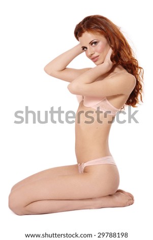 stock photo Beautiful sexy slim redhead girl in pink lingerie sitting on 