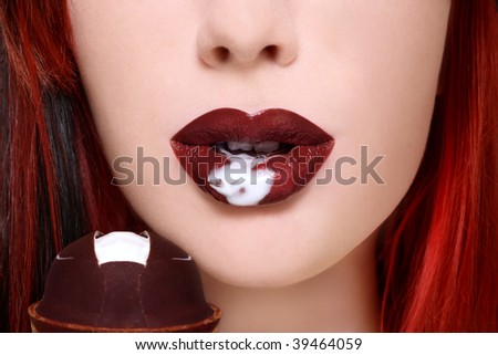 Close-up shot of beautiful woman lips with chocolate ice-cream, selective focus