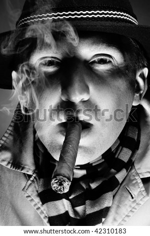 Black and white close-up old-fashioned portrait of man smoking cigar