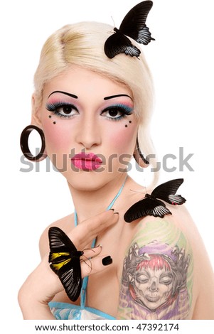 stock photo Beautiful blond tattooed girl with fancy makeup and tropical