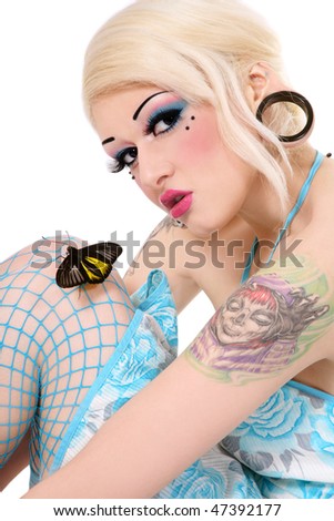 stock photo Beautiful blond tattooed girl with bright makeup and tropical 