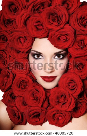 Portrait of beautiful young girl with red roses around her head