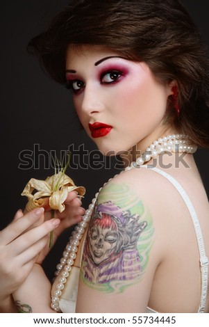 stock photo Portrait of beautiful young tattooed woman in vintage corset