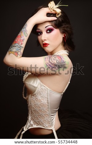 stock photo : Beautiful slim young tattooed woman in ballet skirt and 