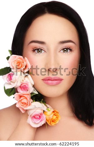 Portrait of young beautiful woman with clear make-up and fresh tender roses over white background