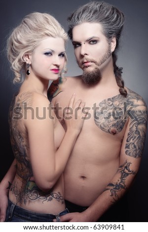 stock photo Pierced tattooed man and woman with oldfashioned makeup and