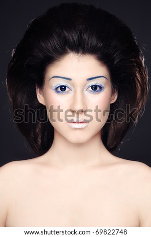 Portrait of young beautiful woman with sparkly futuristic make-up