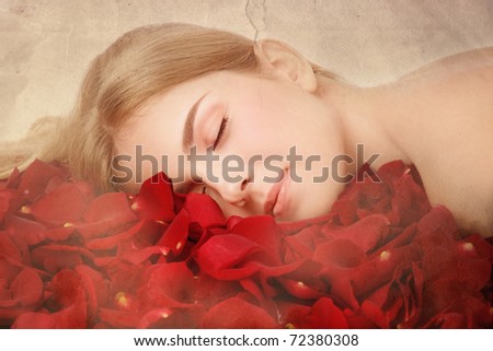 Duotone colored shot of young beautiful woman sleeping in red rose petals on vintage damaged grainy background