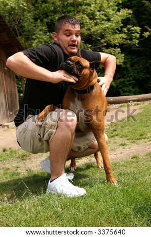 A man being attacked by a boxer dog, slight motion blur in face to show movement in the attack