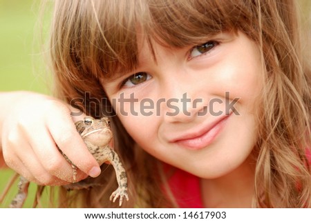 A cute young girl holding her toad