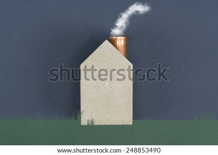 Conceptual house with billowing smoke emitting from the chimney depicting energy efficiency, alternative eco friendly fuel or air pollution and carbon dioxide emission, with copyspace