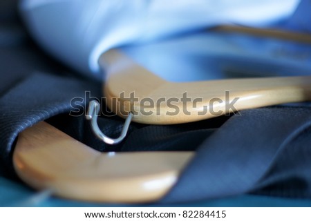 Sport coat and shirt on clothes hangers