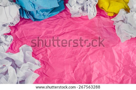 Pink Crumpled paper background with crumpled paper ball.
