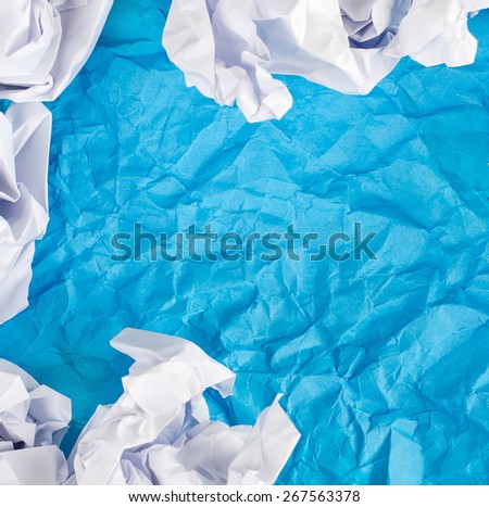 Blue Crumpled paper background with crumpled paper ball.