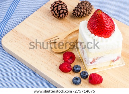 Strawberry cake on wooden background, Cake with strawberries, Piece of cake, raspberries and blueberrys.