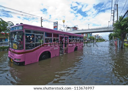 BANGKOK, THAILAND-OCTOBER 29: A local bus is running along the massive disaster street which result from the vast flooding on October 29, 2011 in Bangkok, Thailand.