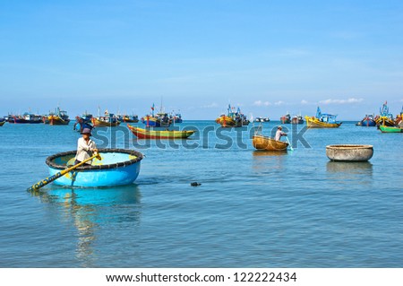 MUI NE, VIETNAM-APRIL 12: Local fisherman travels by basket boat. Mui Ne, a famous tourist destination fishing village in southern of Vietnam on April 12, 2012 in Mui Ne, Vietnam.