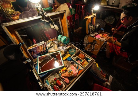 BANGKOK, THAILAND - JANUARY 18: The box of cosmetic set and a Chinese actor is doing make up before the show of traditional Chinese opera on January 18, 2015 in Bangkok, Thailand.