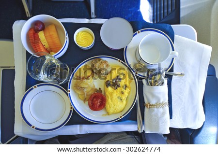 Breakfast meal with omelet and fruit on airline travelling.