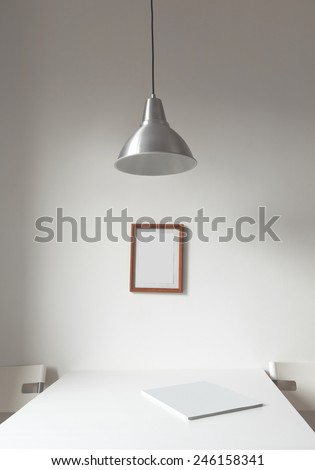 Minimalistic interior of the cafe in white. Two chairs and white table with magazine on it.