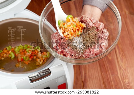 cooking ground meat with roasted vegetables in multicooker closeup
