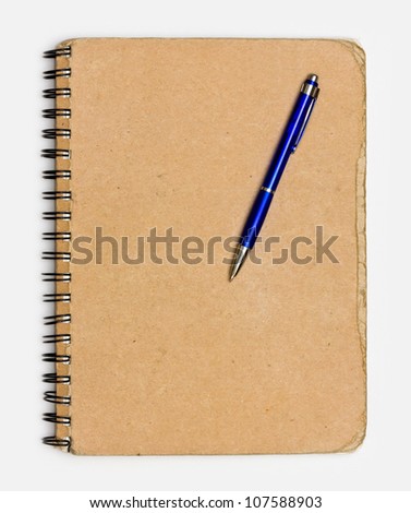 recycled paper notebook front cover with a pen
