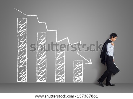 Young business man with  failure chart