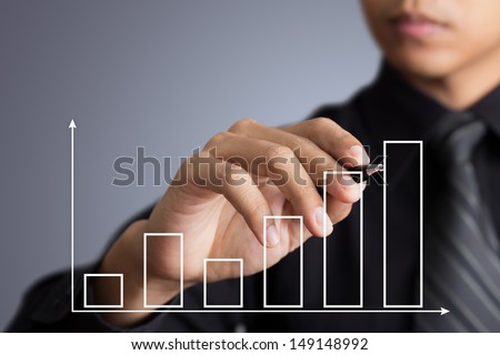 Business man drawing a growth graph