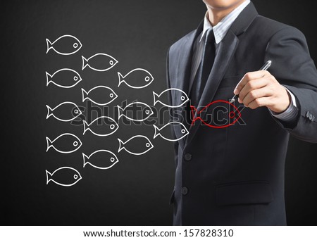 Businessman Drawing Fishes In Group Leadership Concept