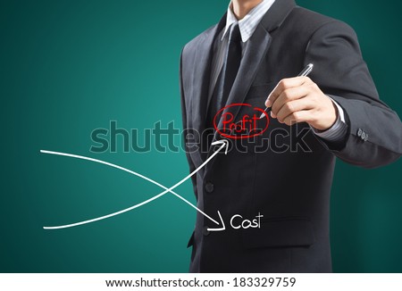 Business man drawing graph of profit compare with cost