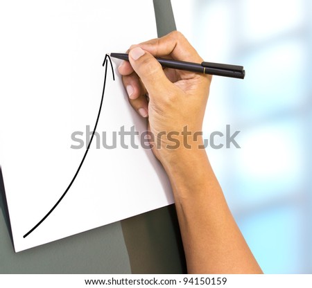 Business hand drawing a rising arrow, representing business growth.