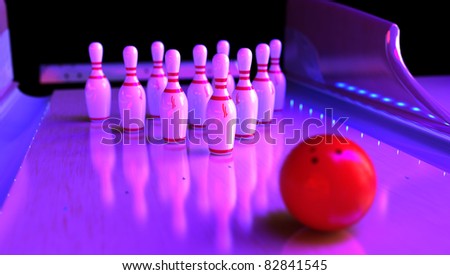 Ten skittles with red ball on bowling lane