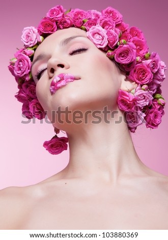 Young girl with pink rose flower in hair