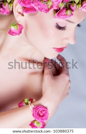 Young girl with pink rose flower in hair